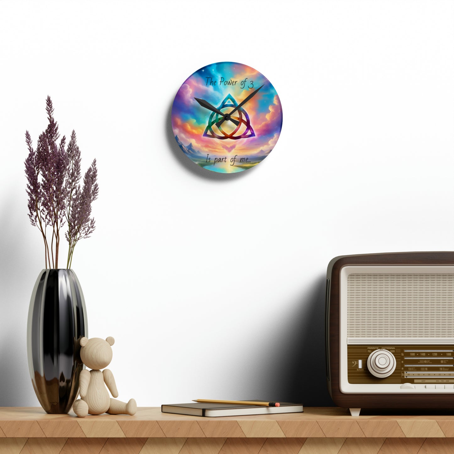 Acrylic Wall Clock, the power of 3 is part of me affirmation, brightly coloured sky with a triquetra symbol on it.