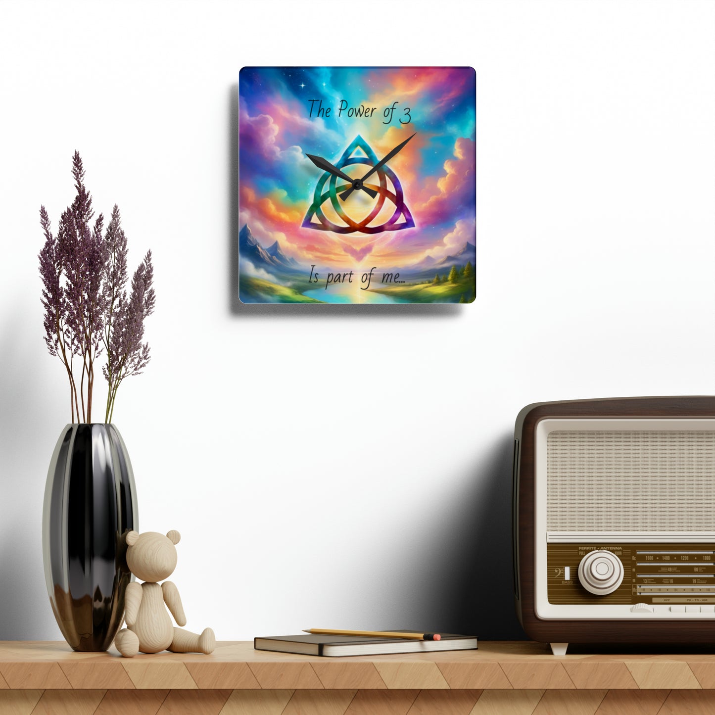 Acrylic Wall Clock, the power of 3 is part of me affirmation, brightly coloured sky with a triquetra symbol on it.