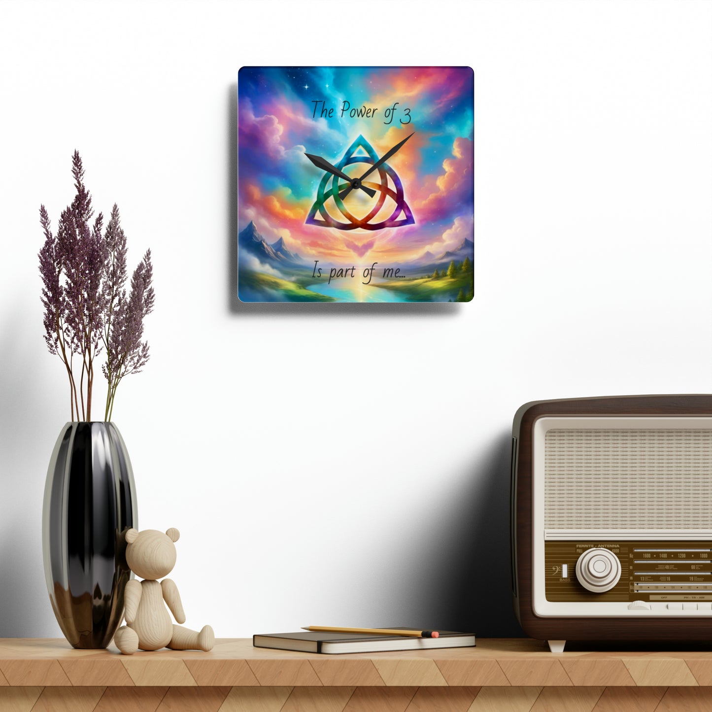 Acrylic Wall Clock, the power of 3 is part of me affirmation, brightly coloured sky with a triquetra symbol on it.