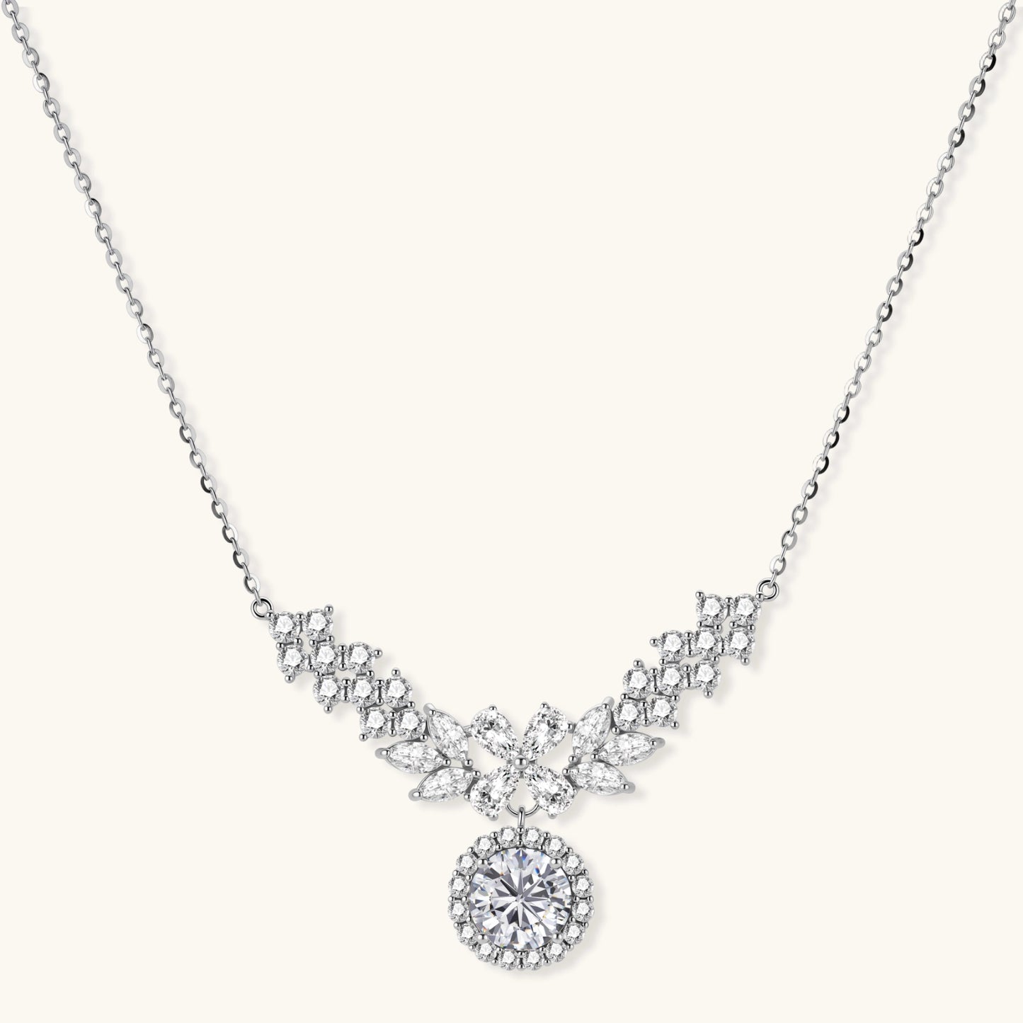 Elegant sterling silver necklace featuring intricate wing-like design with brilliant moissanite stones on neutral background.