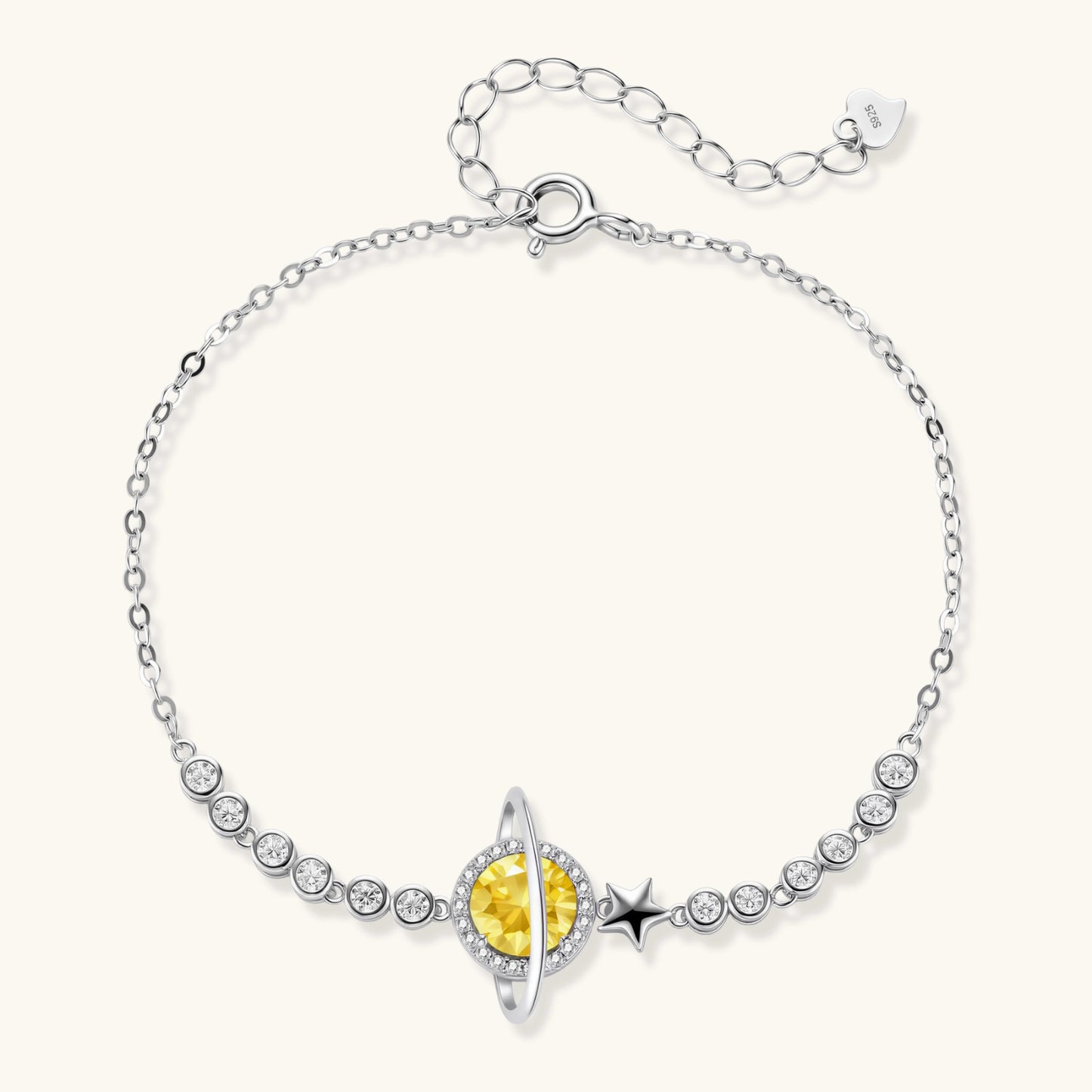 Sterling silver bracelet with yellow moissanite centerpiece in oval setting, crystal chain, and star charm on white background.