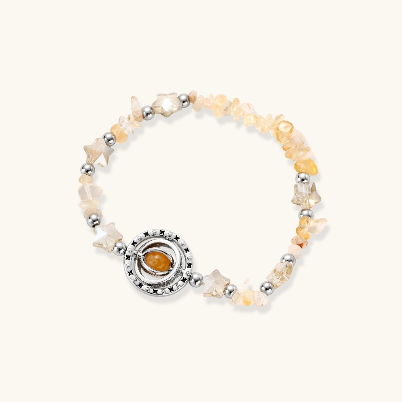 Stretchable bracelet with cream citrine stone chips, brass beads, and central amber zirconia pendant on neutral background.