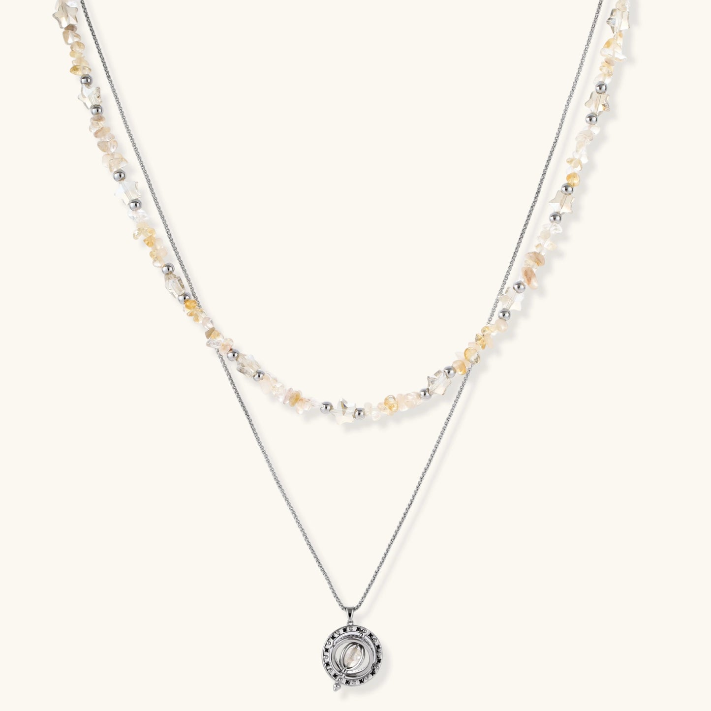 Two-layer necklace with natural stone chips and eco-brass beads, featuring a circular wrapped pendant on cream background.