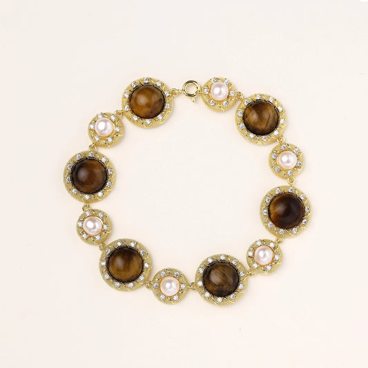 Gold-plated link bracelet with alternating brown tiger's eye stones and white freshwater pearls in ornate bezels.