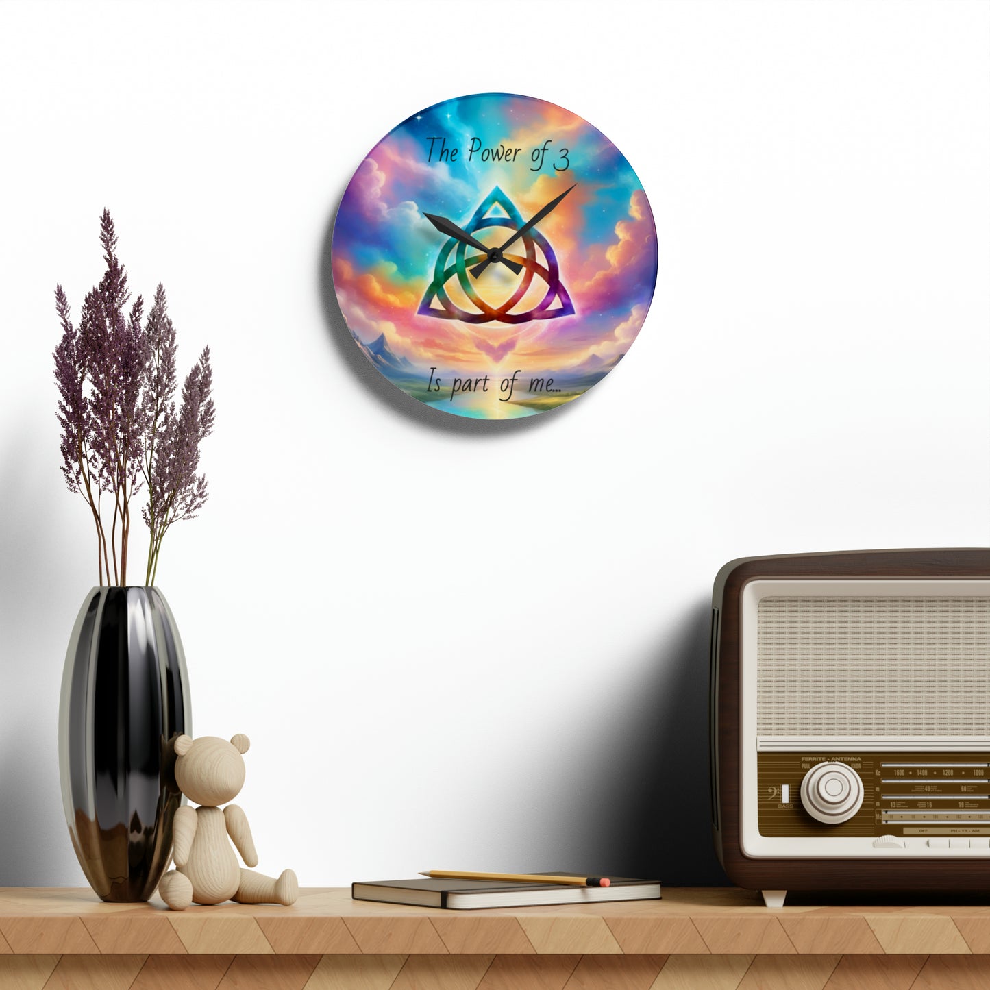 Acrylic Wall Clock, the power of 3 is part of me affirmation, brightly coloured sky with a triquetra symbol on it.