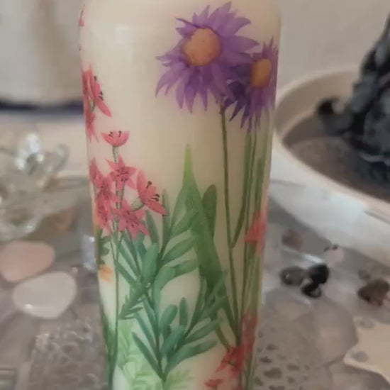 Pillar candle with floral, multiple flowers growing up from the bottom of the candle to the top , 50 hour burning